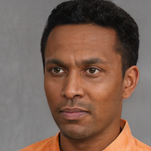 Neutral black adult male with short  black hair and brown eyes