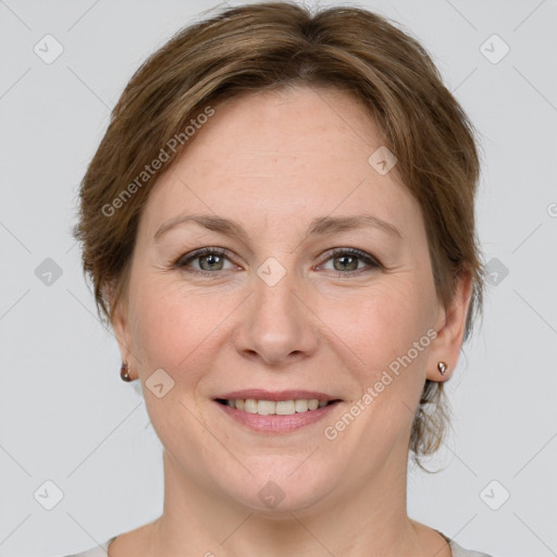 Joyful white adult female with medium  brown hair and grey eyes