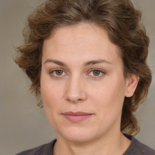 Joyful white young-adult female with medium  brown hair and green eyes