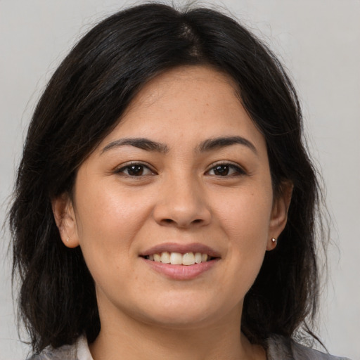 Joyful asian young-adult female with medium  brown hair and brown eyes