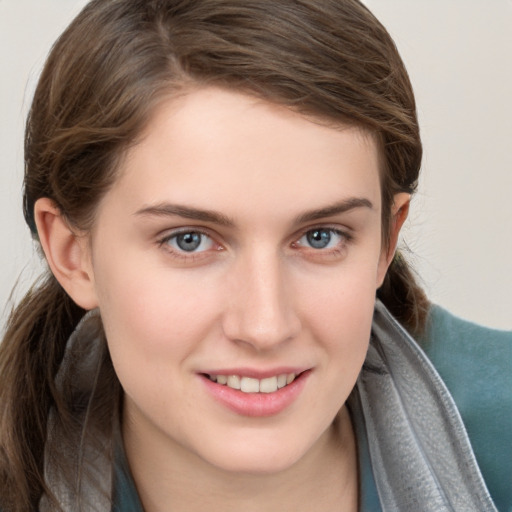 Joyful white young-adult female with long  brown hair and grey eyes