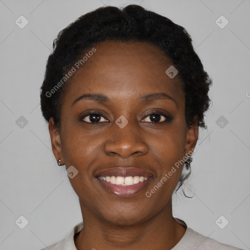 Joyful black young-adult female with short  black hair and brown eyes