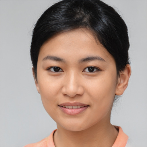 Joyful asian young-adult female with medium  brown hair and brown eyes