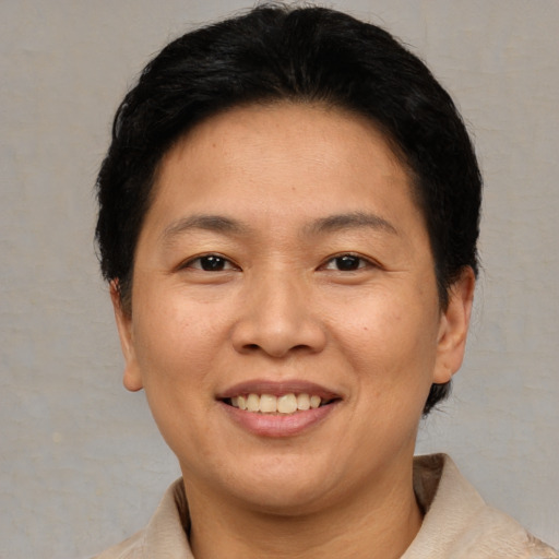 Joyful asian adult female with short  brown hair and brown eyes