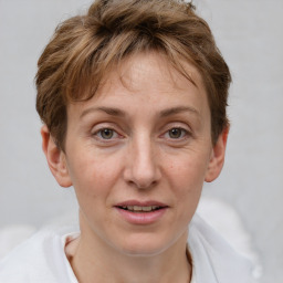 Joyful white adult female with short  brown hair and grey eyes