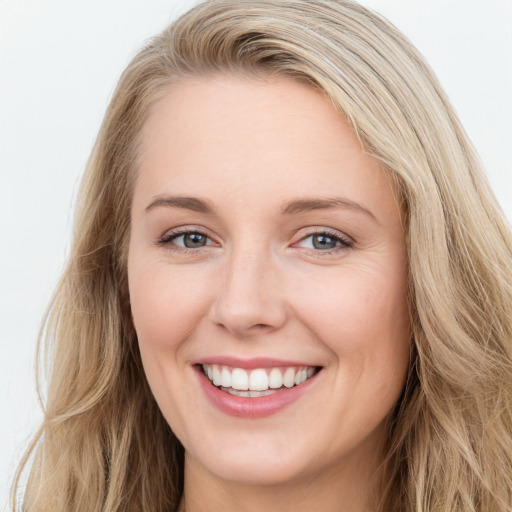 Joyful white young-adult female with long  brown hair and blue eyes