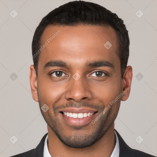 Joyful black young-adult male with short  brown hair and brown eyes