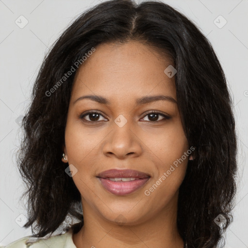 Joyful black young-adult female with long  brown hair and brown eyes