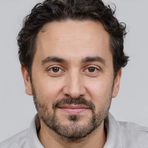 Joyful white adult male with short  brown hair and brown eyes