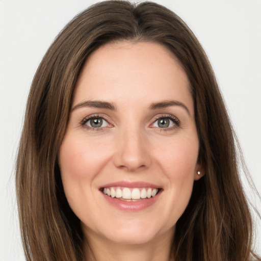 Joyful white young-adult female with long  brown hair and grey eyes