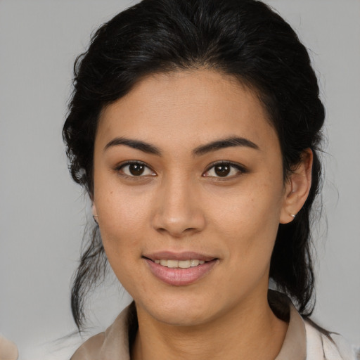 Joyful latino young-adult female with medium  brown hair and brown eyes