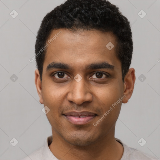 Joyful black young-adult male with short  black hair and brown eyes