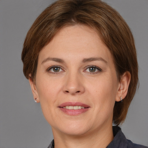 Joyful white adult female with medium  brown hair and grey eyes