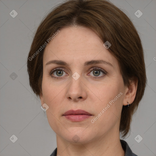 Joyful white adult female with medium  brown hair and grey eyes