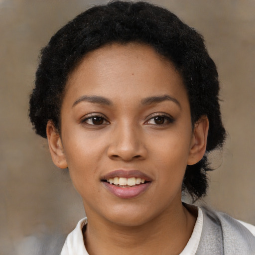 Joyful latino young-adult female with short  black hair and brown eyes