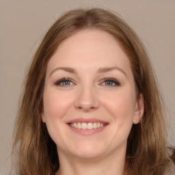 Joyful white young-adult female with long  brown hair and grey eyes