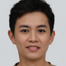 Joyful asian young-adult male with short  brown hair and brown eyes