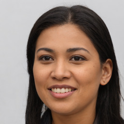 Joyful latino young-adult female with long  brown hair and brown eyes