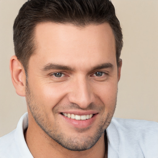 Joyful white young-adult male with short  brown hair and brown eyes