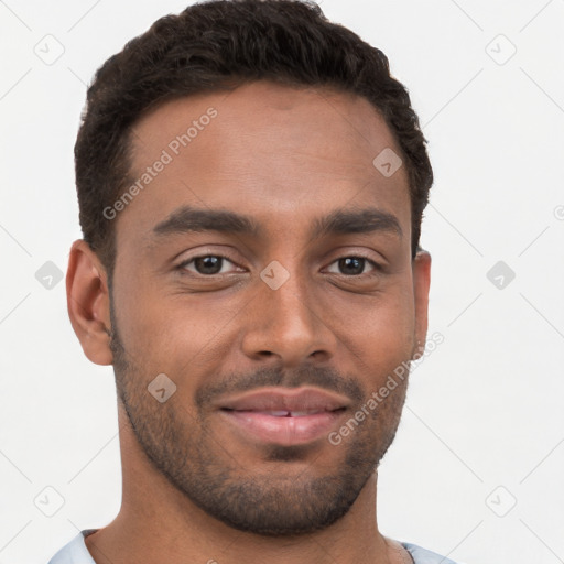 Joyful black young-adult male with short  brown hair and brown eyes