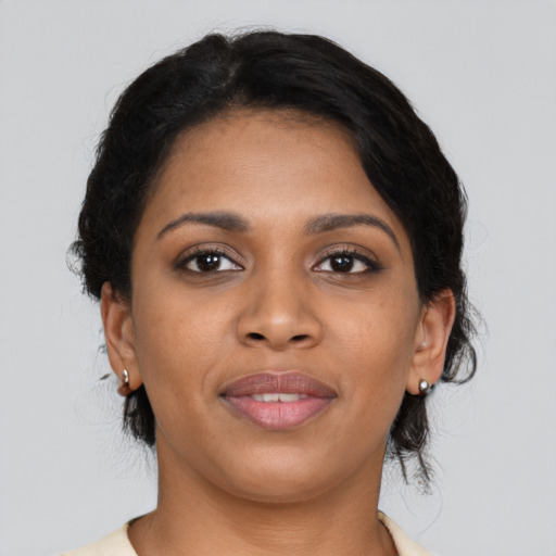 Joyful black young-adult female with medium  brown hair and brown eyes