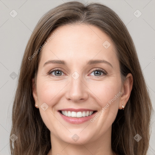 Joyful white young-adult female with long  brown hair and grey eyes