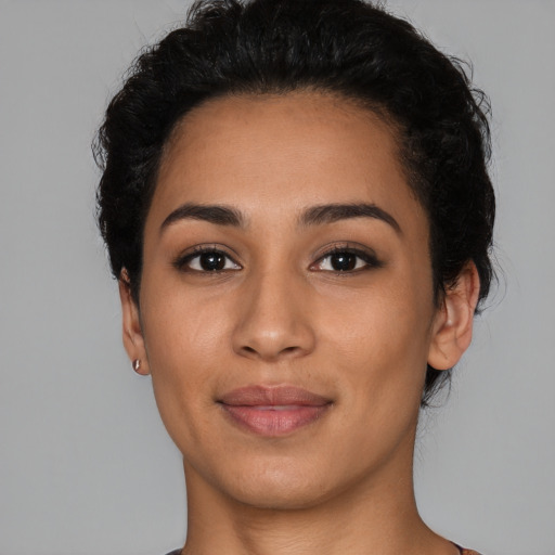Joyful latino young-adult female with short  black hair and brown eyes