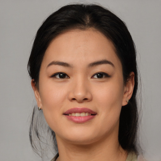 Joyful asian young-adult female with long  black hair and brown eyes