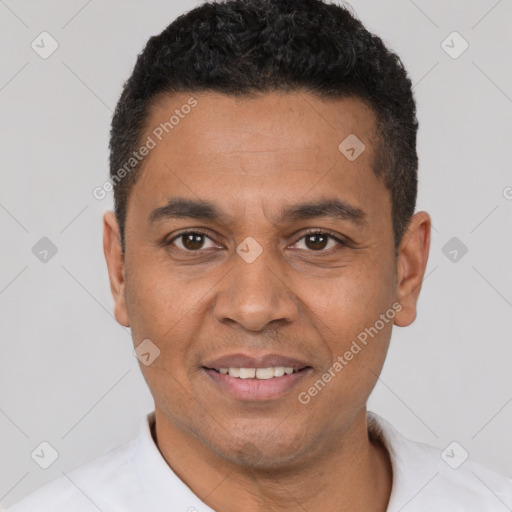 Joyful white adult male with short  black hair and brown eyes