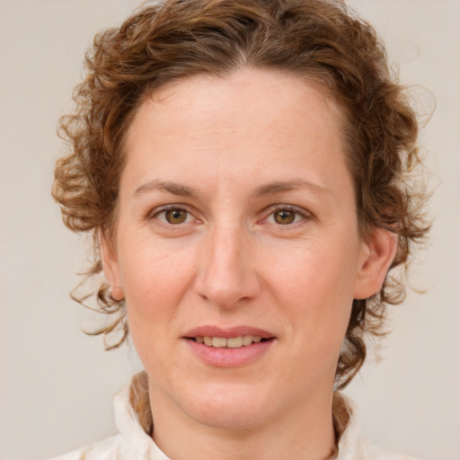 Joyful white young-adult female with medium  brown hair and green eyes