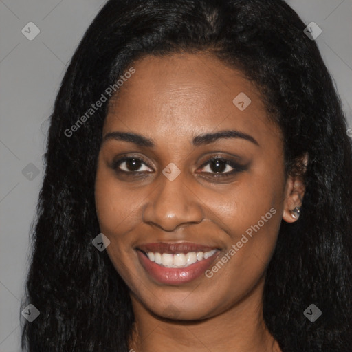 Joyful black young-adult female with long  black hair and brown eyes