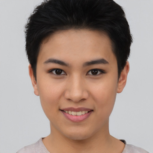 Joyful asian young-adult female with short  black hair and brown eyes
