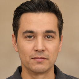 Joyful white adult male with short  black hair and brown eyes