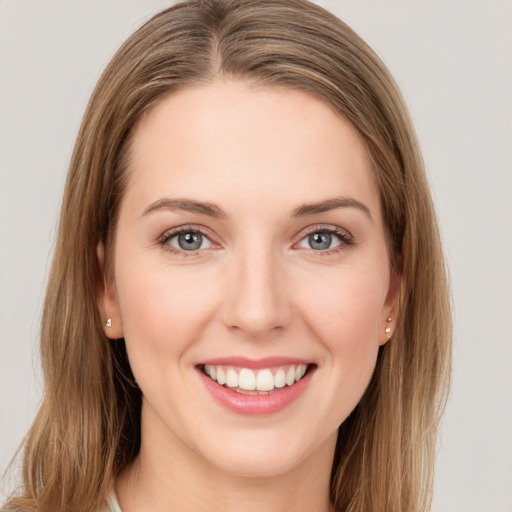 Joyful white young-adult female with long  brown hair and green eyes