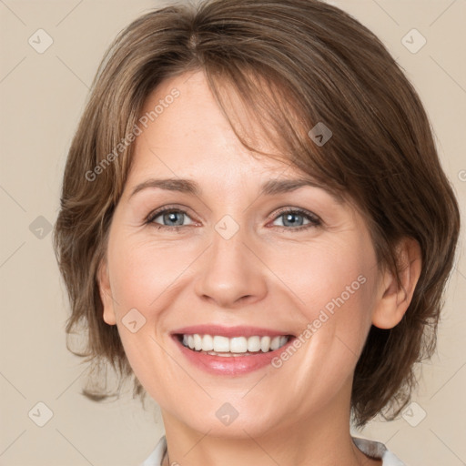 Joyful white young-adult female with medium  brown hair and grey eyes