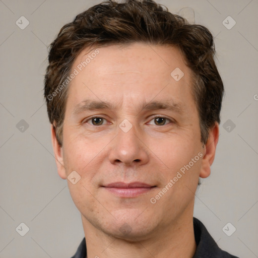 Joyful white adult male with short  brown hair and grey eyes