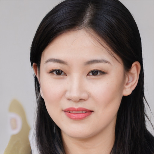 Joyful asian young-adult female with long  brown hair and brown eyes