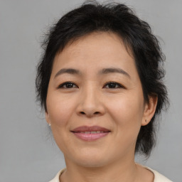 Joyful asian adult female with medium  brown hair and brown eyes