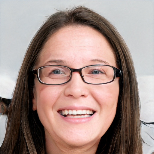 Joyful white adult female with long  brown hair and blue eyes