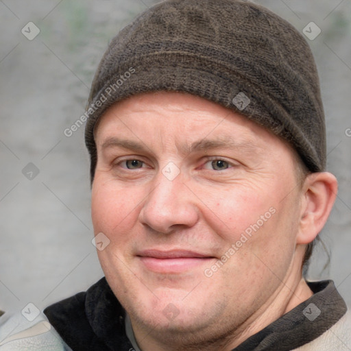 Joyful white adult male with short  brown hair and grey eyes