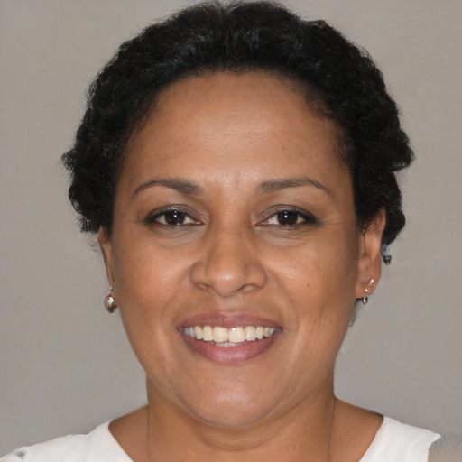 Joyful black adult female with short  brown hair and brown eyes