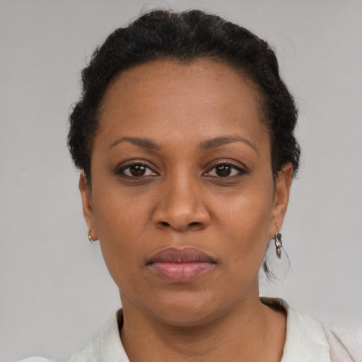 Joyful black adult female with short  brown hair and brown eyes