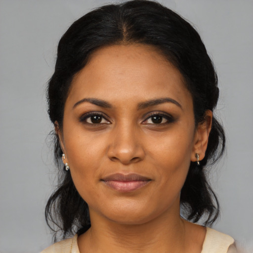 Joyful black young-adult female with medium  black hair and brown eyes