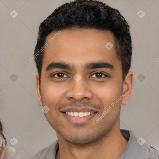 Joyful latino young-adult male with short  black hair and brown eyes