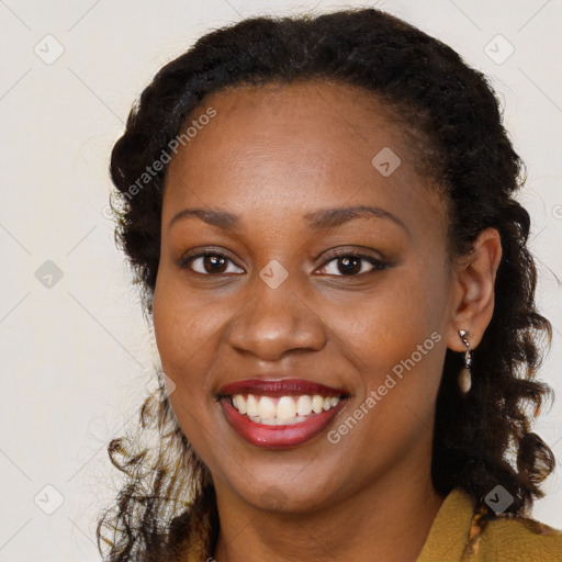 Joyful black young-adult female with long  brown hair and brown eyes