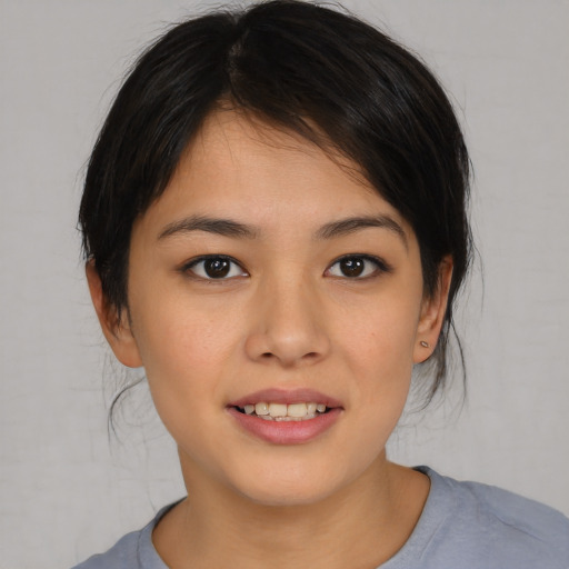 Joyful asian child female with medium  brown hair and brown eyes