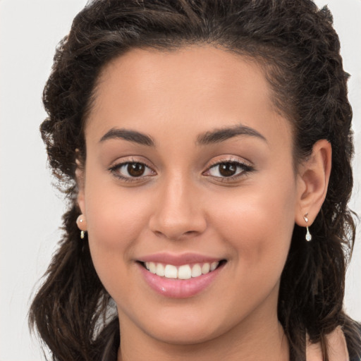 Joyful white young-adult female with long  brown hair and brown eyes