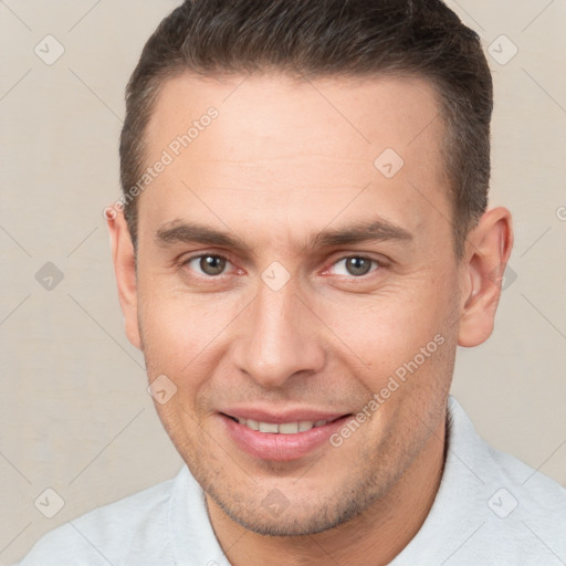 Joyful white young-adult male with short  brown hair and brown eyes