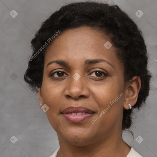 Joyful black adult female with short  brown hair and brown eyes