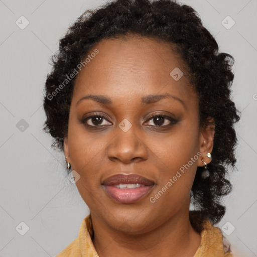 Joyful black adult female with long  brown hair and brown eyes